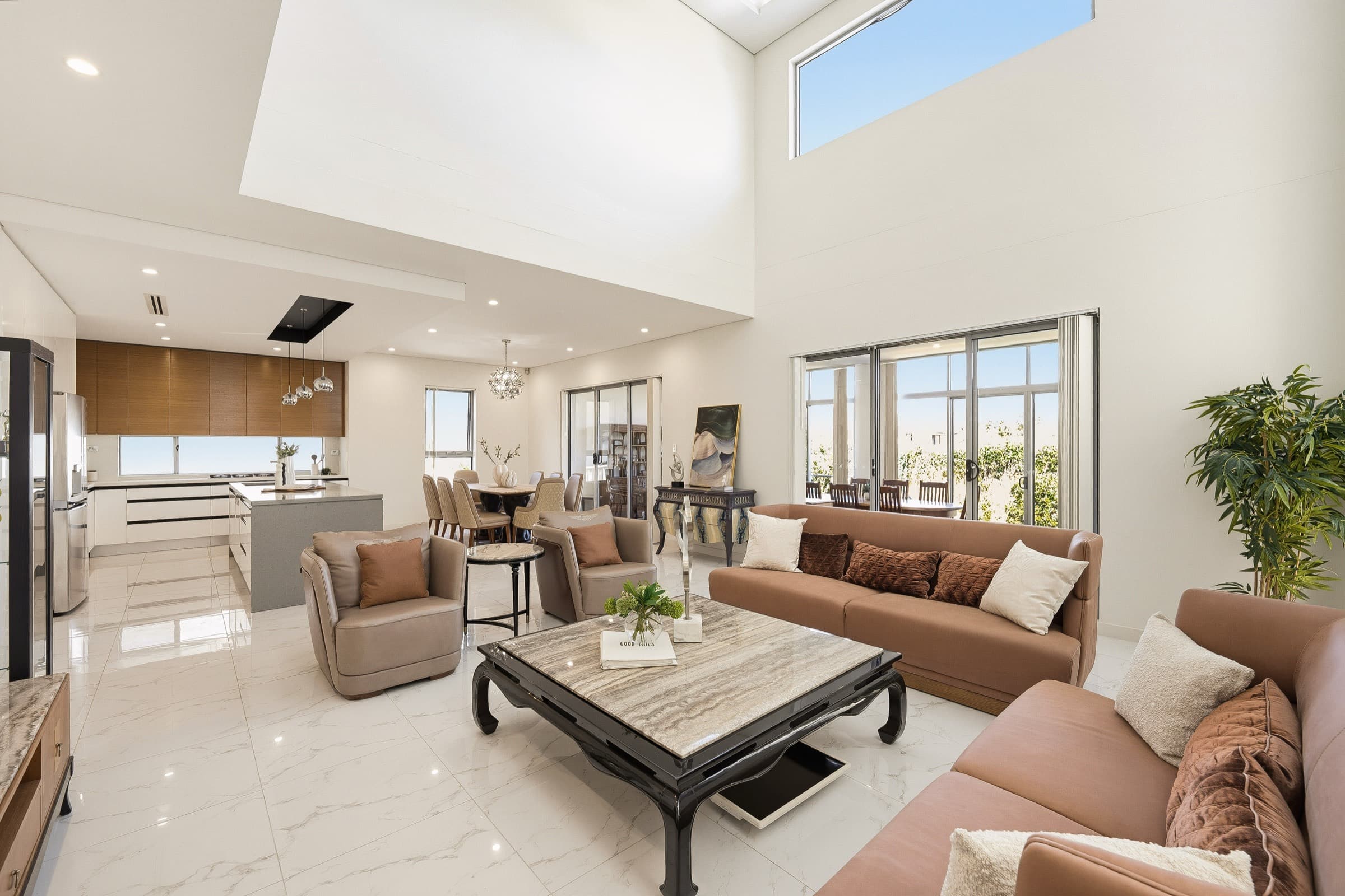 Open-plan living and dining area with double-height ceiling