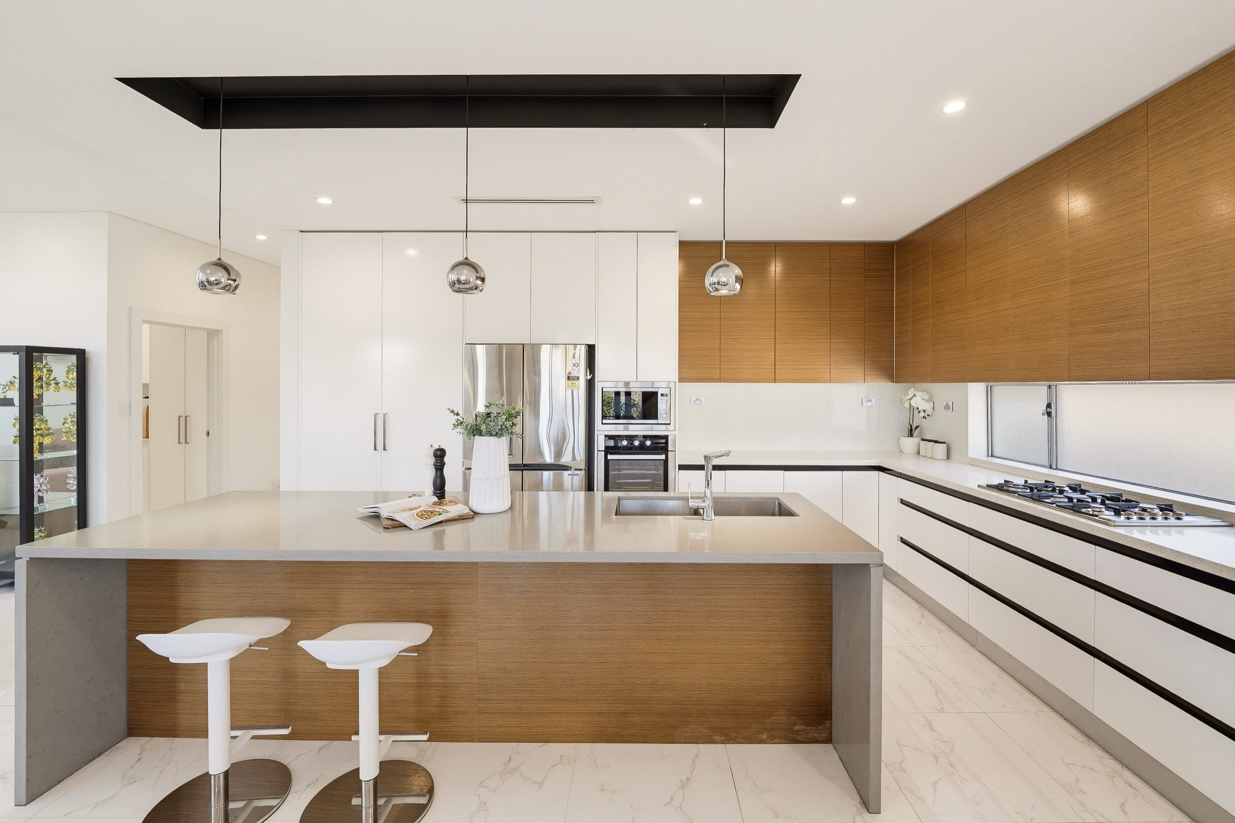 Modern kitchen with timber joinery and stone island bench